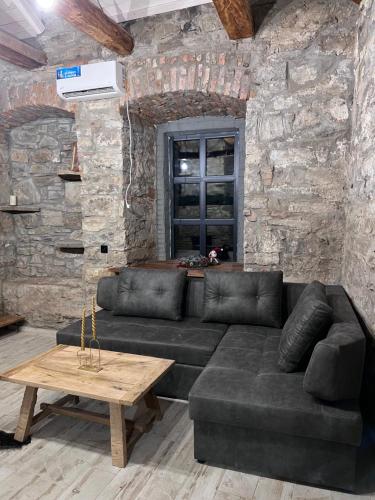 a living room with a black couch and a table at Luxury Live in Kamianets-Podilskyi