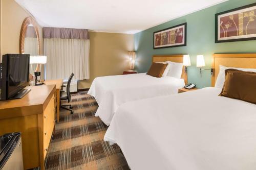 a hotel room with two beds and a flat screen tv at SureStay Plus Hotel by Best Western Jasper in Jasper