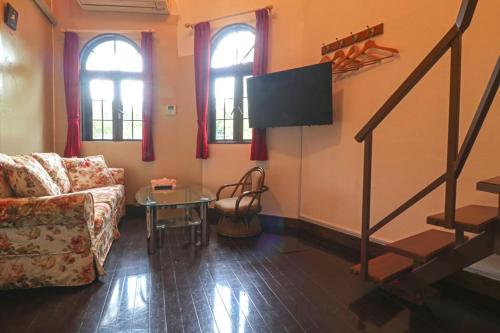 a living room with a couch and a flat screen tv at Nikko Park Lodge Mountain Side in Nikko