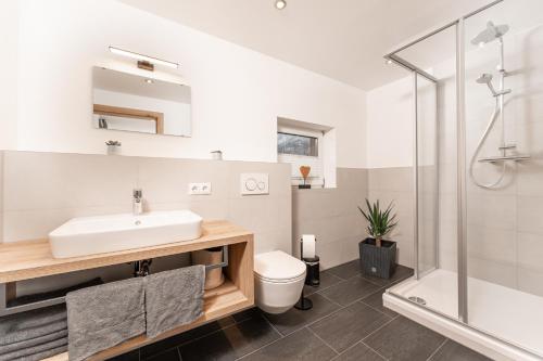 a bathroom with a sink and a shower at Bergnest Oetztal - Appartements in Umhausen