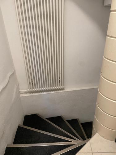 een wenteltrap met een radiator in een kamer bij Haus zur Eiche Private 3,5 Zimmerwohnung bis zu 8 Gäste in Chur