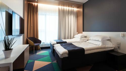 a hotel room with two beds and a window at Hotel Sophia by Tartuhotels in Tartu