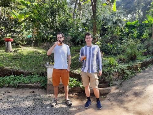 two men standing next to each other in a park at Sopanam Heritage Thekkady in Thekkady