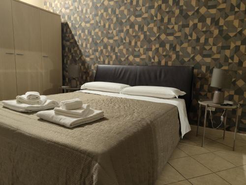 A bed or beds in a room at Hotel Trieste