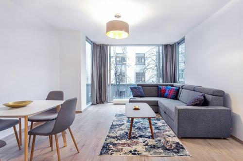 a living room with a couch and a table at Business Apartment In Jaksto Street in Vilnius