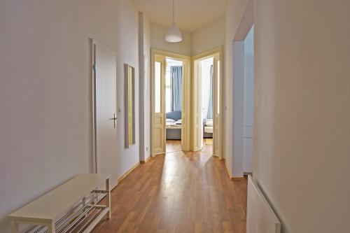 a hallway with white walls and a wooden floor at Vienna City Apartments 1090 Vienna in Vienna