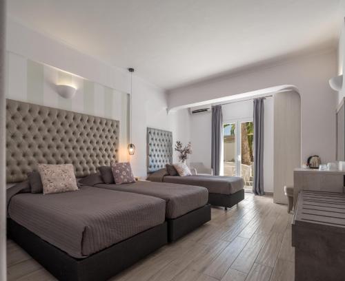 a living room with a bed and a couch at Daedalus Hotel in Fira