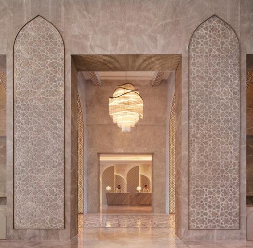 a lobby with two arches and a chandelier at Taj Amer, Jaipur in Jaipur