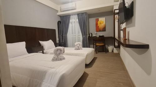 Tempat tidur dalam kamar di Sienna Residence Bogor