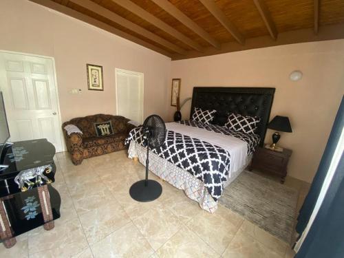 Una cama o camas en una habitación de Portmore - Private AFFORDABLE Bedroom - FAN ONLY with Pay Per Use AC OR - FULL AC Choose Standard room or Superior King Accordingly