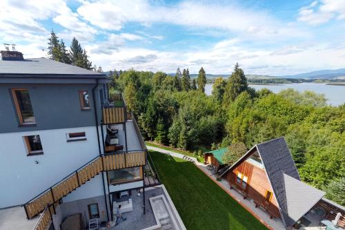 an aerial view of a house with a view of a lake at AKORD chata in Námestovo