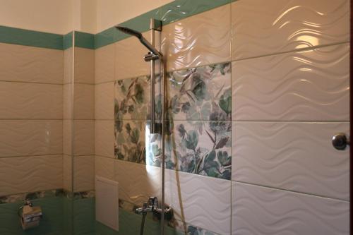 a shower with a glass door in a bathroom at Guest House Zhelevi in Sozopol