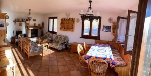 a kitchen and living room with a table and chairs at Casa vacanze Ravascletto in Ravascletto