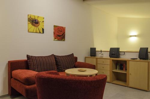 a living room with a couch and a table at Ferienwohnung Radebeul Gerlach in Radebeul