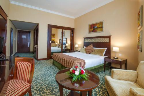 A bed or beds in a room at Concorde Hotel - Fujairah