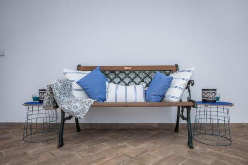 a bench with blue and white pillows on it at Cabo de Sagres -2 bedroom apartment in Sagres