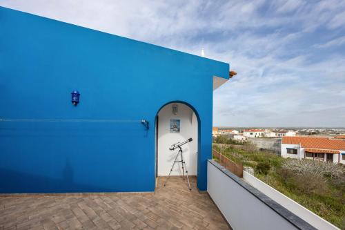 a blue building with a telescope on a balcony at Cabo de Sagres -2 bedroom apartment in Sagres