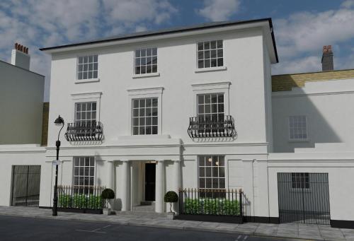 a white building with black fences in front of it at No.4 Carlton in Southampton