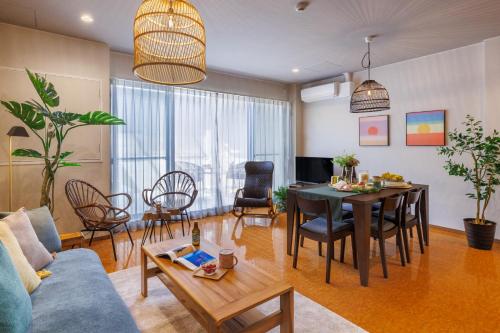 a living room with a blue couch and a table at Southerlies Condominium Onna in Onna