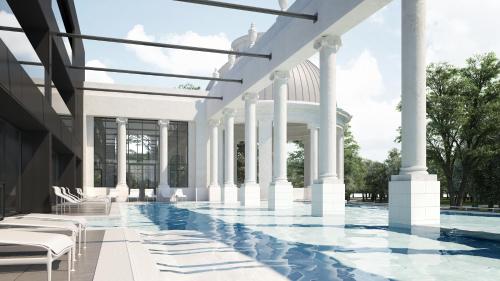 une piscine avec colonnes et un bâtiment dans l'établissement Villa Thermae Nancy, à Nancy