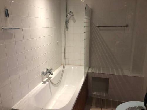 a bathroom with a shower and a tub and a toilet at Les Lumerettes - Dohan in Bouillon