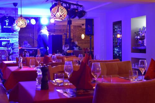 a restaurant with tables and chairs with wine glasses at Black Forest Hotel Kappel-Grafenhausen in Kappel-Grafenhausen