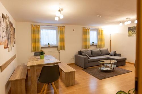 a living room with a couch and a table at Ferienwohnung am Bach in Oberkotzau