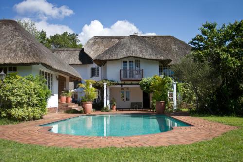 een huis met een zwembad ervoor bij Summerhill Guest Estate in Pinetown