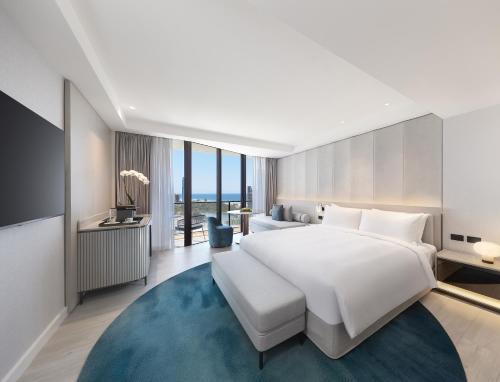 ein Schlafzimmer mit einem großen weißen Bett und einem blauen Teppich in der Unterkunft JW Marriott Gold Coast Resort & Spa in Gold Coast