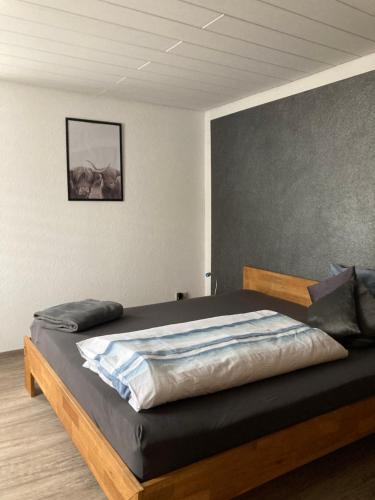 a bedroom with a large bed with a wooden frame at Ferienwohnung Petra in Rust