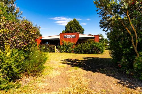 a house with an orange building in a yard at Bellarine Lodge Sleeps 30 in Drysdale