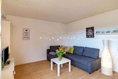 a living room with a blue couch and a table at Wächtersberg in Wildberg