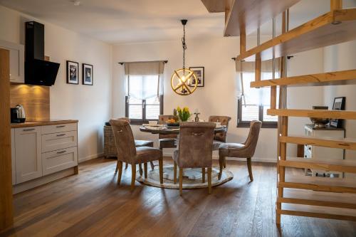 a kitchen and dining room with a table and chairs at Suite Home Apartments in Weimar