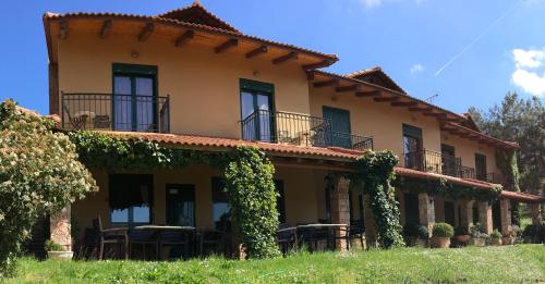 a house with ivy on the side of it at Aphrodite's Inn Kalavrita in Kalavrita