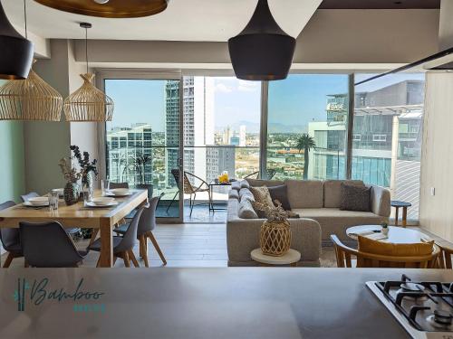 a living room with a couch and a table at Luxury Condo in Lobby33 near Andares By Bamboo in Guadalajara