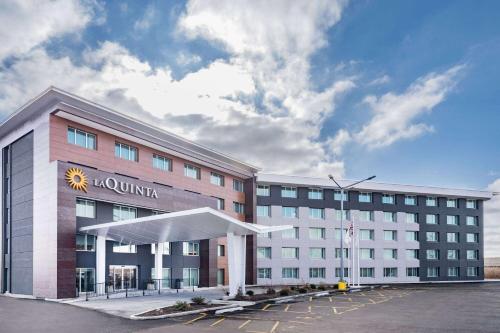 a hotel with a sun sign on the front of it at La Quinta by Wyndham Chicago O'Hare Airport in Rosemont