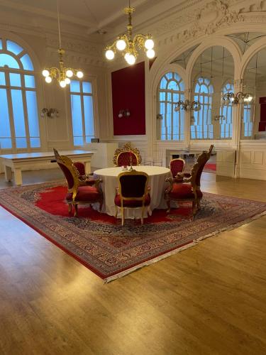 a dining room with a table and chairs in a building at Salon Boyer in Épernay