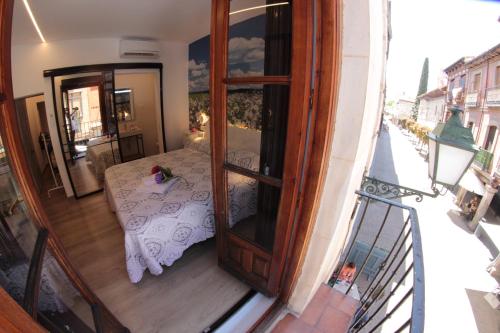 a balcony with a room with a bed on a balcony at FP HOTELs in Alcalá de Henares