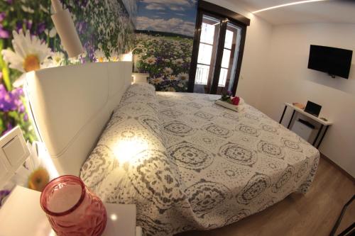 a bedroom with a bed with a white bedspread at FP HOTELs in Alcalá de Henares