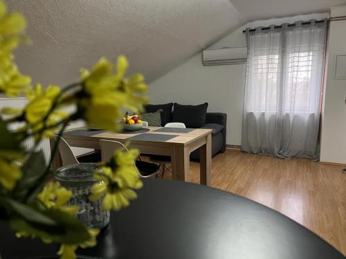 a living room with a table and a couch at Apartment Buga Bilje in Bilje