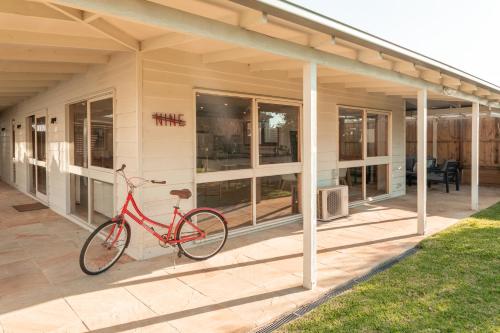 a red bike parked on the side of a building at Torquay Hotel/Motel in Torquay