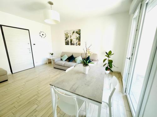 uma sala de estar com uma mesa e um sofá em Emme Apartment em Cagliari