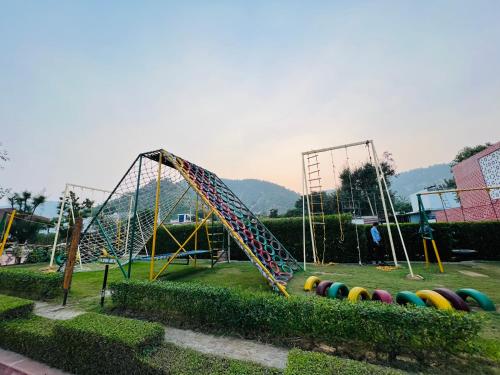 a playground with a slide in a park at DESI THATH RESORT in Alwar