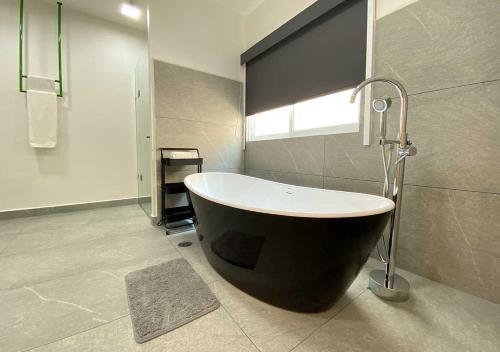 a large bath tub in a bathroom with a window at Estancias VIVE MX wtc in Mexico City