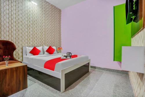 a bedroom with a bed with a sink and a chair at Hotel O K D Guest House in Manesar