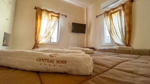 Central 9 Rooms tesisinde bir odada yatak veya yataklar