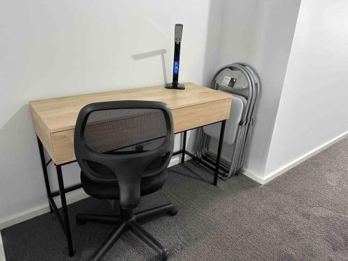 a desk with a chair and a computer monitor on it at Wonderful Jubilee Estate House in Wyndham Vale