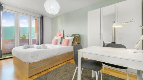 una camera bianca con scrivania e letto di HOMEY Coloc goodLife - Colocation moderne - Chambres privées - Wifi et Netflix - Au pied du tram pour Genève ad Ambilly