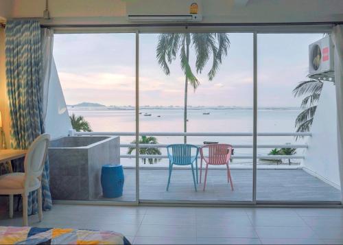 ein Wohnzimmer mit Meerblick in der Unterkunft มารินอส บีชเฮ้าส์ Marinos Beach house in Si Racha