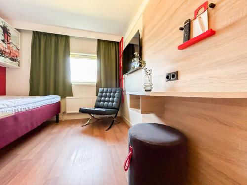 una camera d'albergo con letto e sedia di Good Morning Jönköping a Jönköping